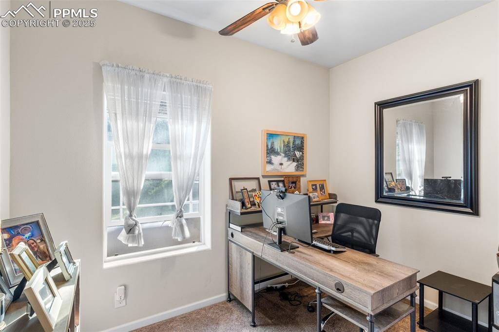 Image 16 of 46: Office space featuring a ceiling fan and carpet