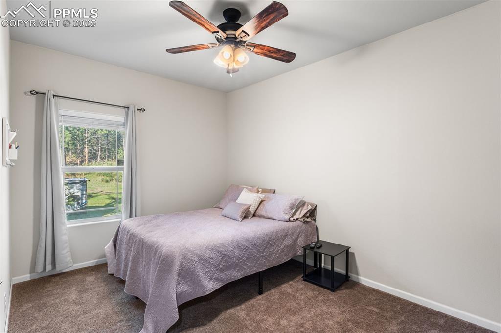 Image 17 of 46: Carpeted bedroom featuring baseboards and ceiling fan