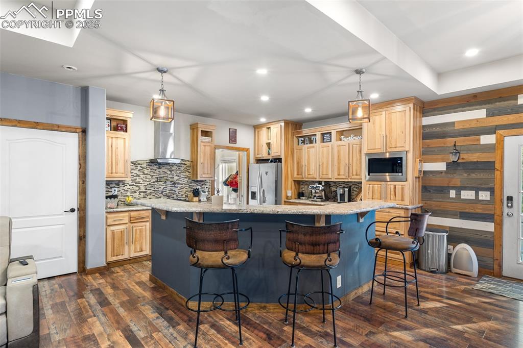 Image 3 of 46: Kitchen with dark wood-style floors, tasteful backsplash, recessed lighting