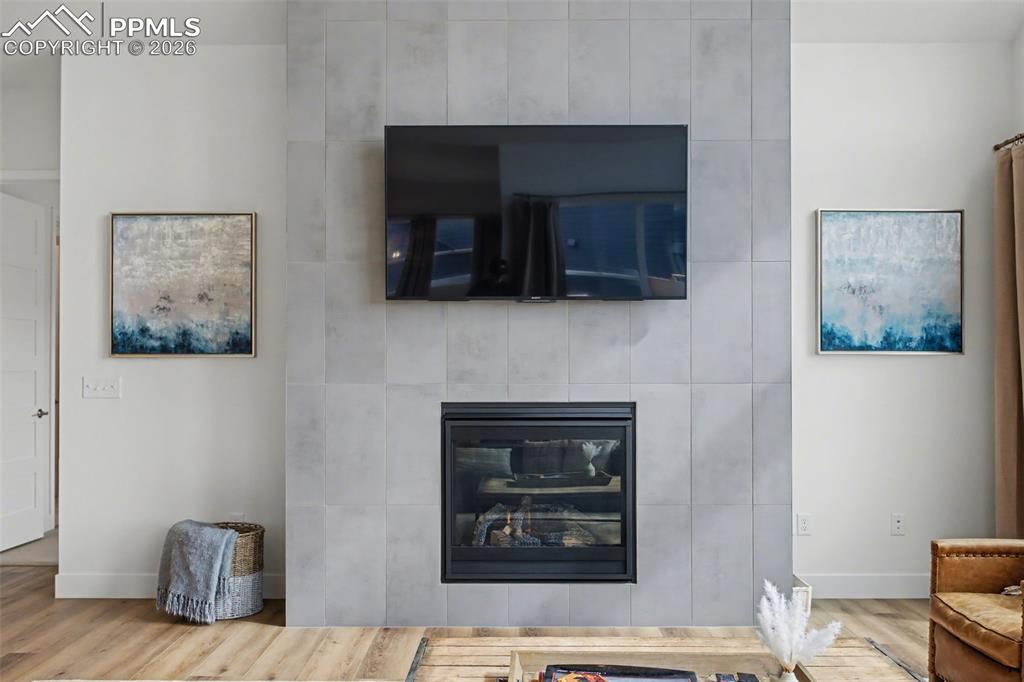 Image 11 of 39: Detailed view of wood finished floors and a fireplace