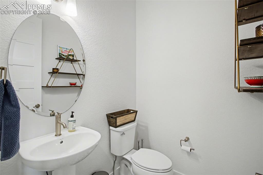 Image 19 of 39: Half bath featuring a textured wall