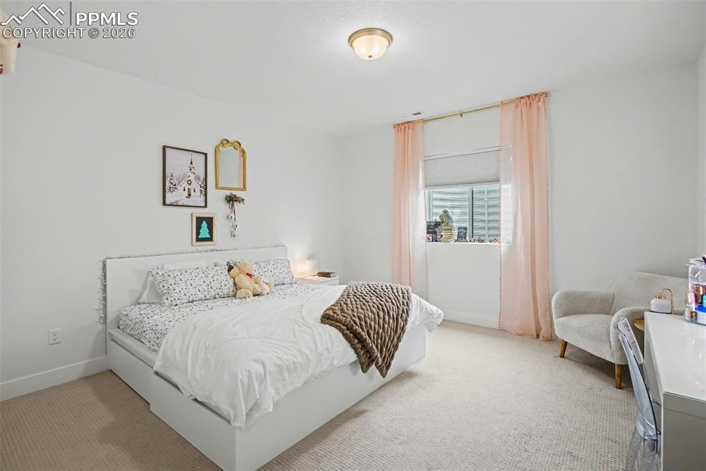 Image 27 of 39: Bedroom featuring light carpet and baseboards