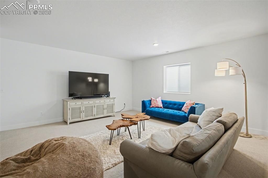 Image 30 of 39: Carpeted living room featuring baseboards