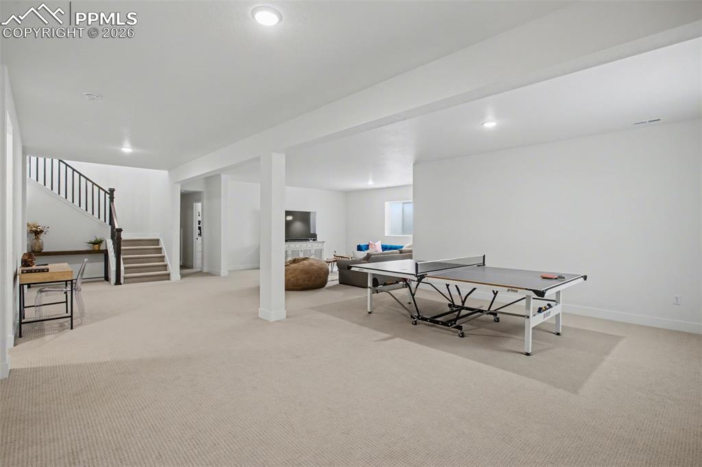 Image 31 of 39: Rec room featuring light colored carpet and recessed lighting