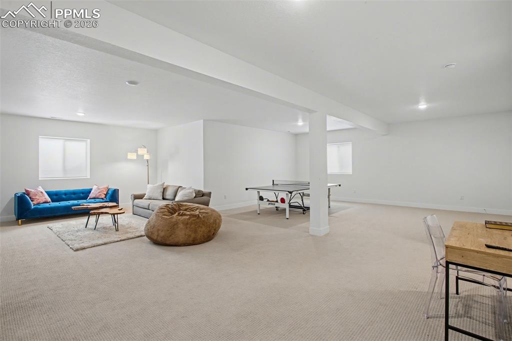 Image 32 of 39: Game room featuring baseboards and carpet