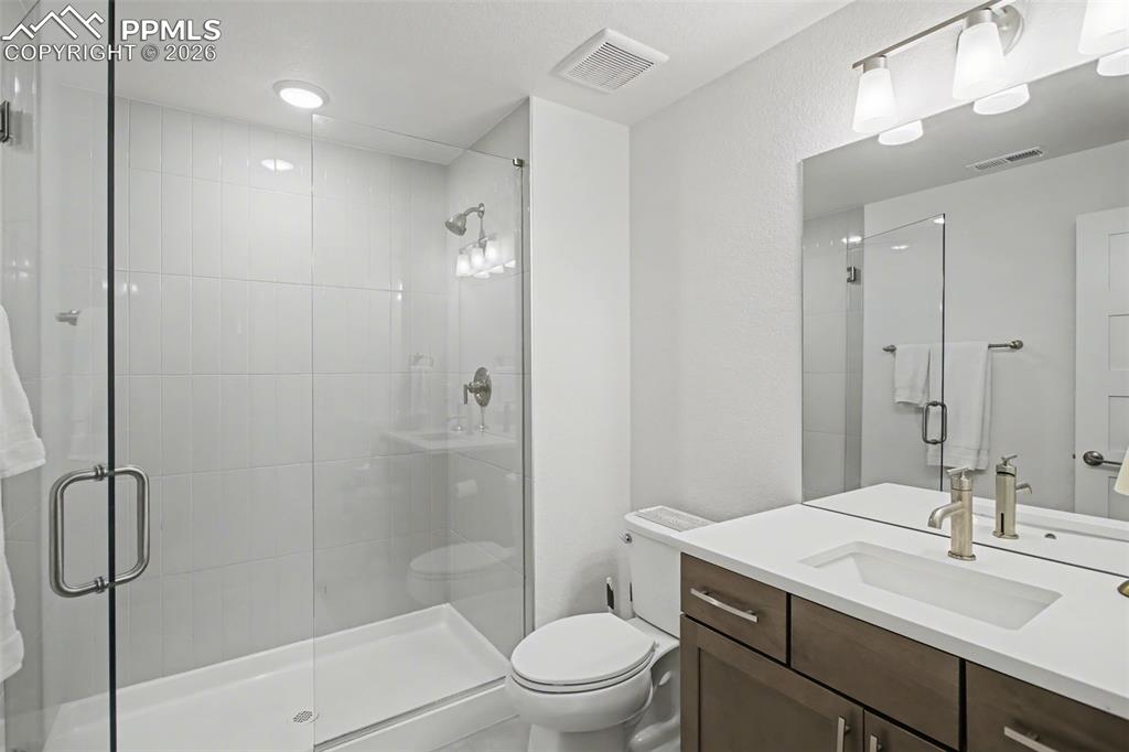 Image 33 of 39: Bathroom featuring vanity and a shower stall
