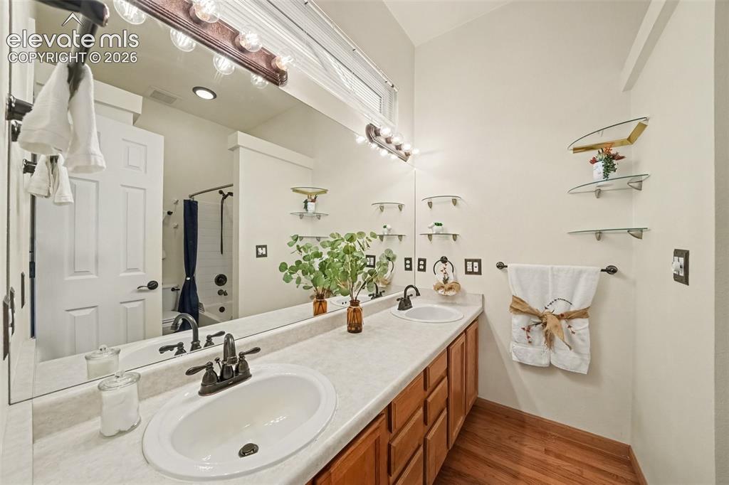 Image 12 of 28: he spacious primary full bathroom features dual sinks, ample counter space,