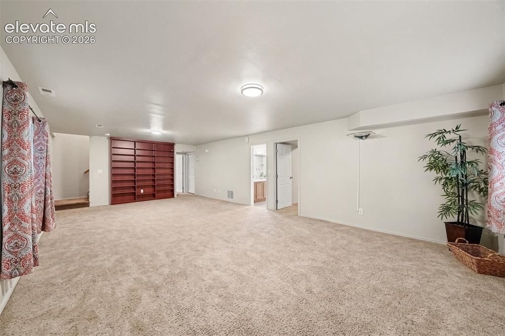 Image 17 of 28: The huge basement family room offers a comfortable gathering space with plu