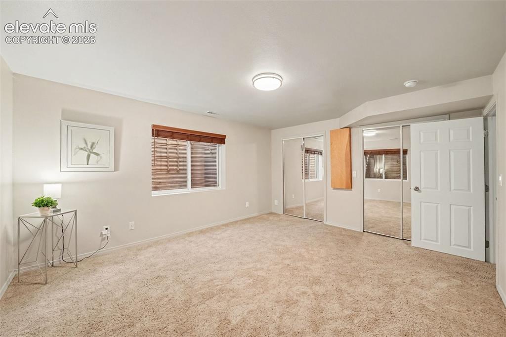 Image 23 of 28: The fifth bedroom offers a versatile space that can be used as a guest room