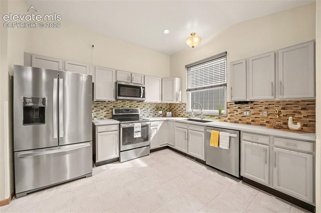 Image 9 of 28: The spacious kitchen features stainless steel appliances, ample cabinetry,