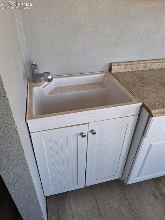 Image 21 of 24: Detailed view of wood finished floors and a textured wall