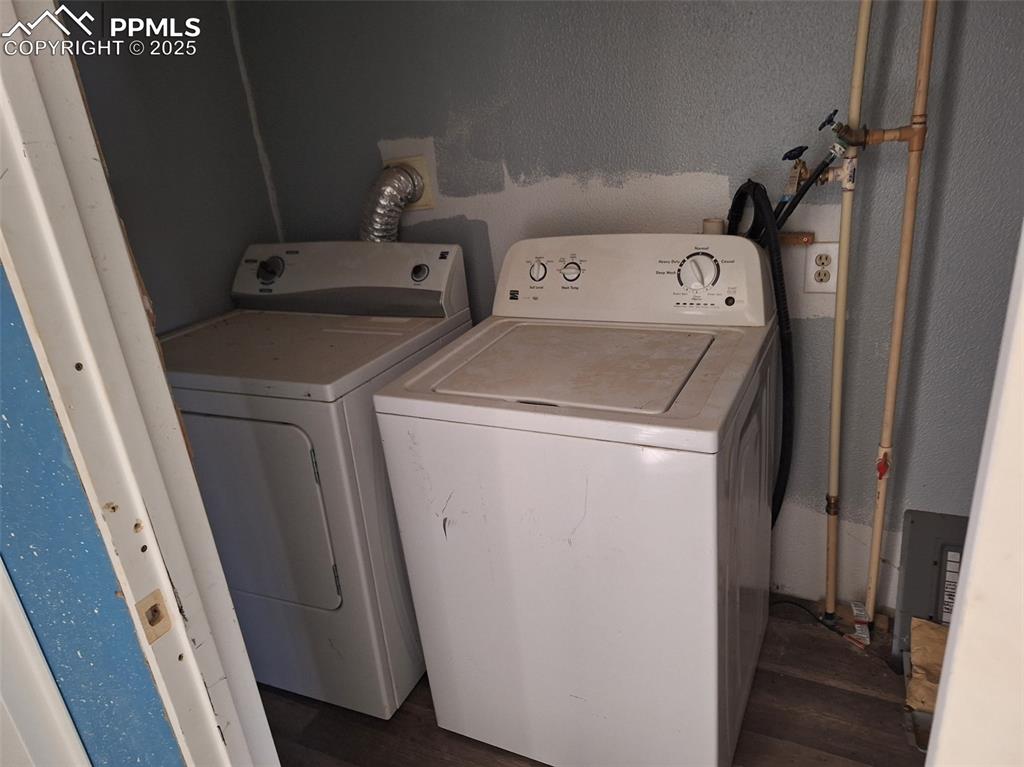 Image 5 of 24: Laundry area with washer and dryer and a textured wall