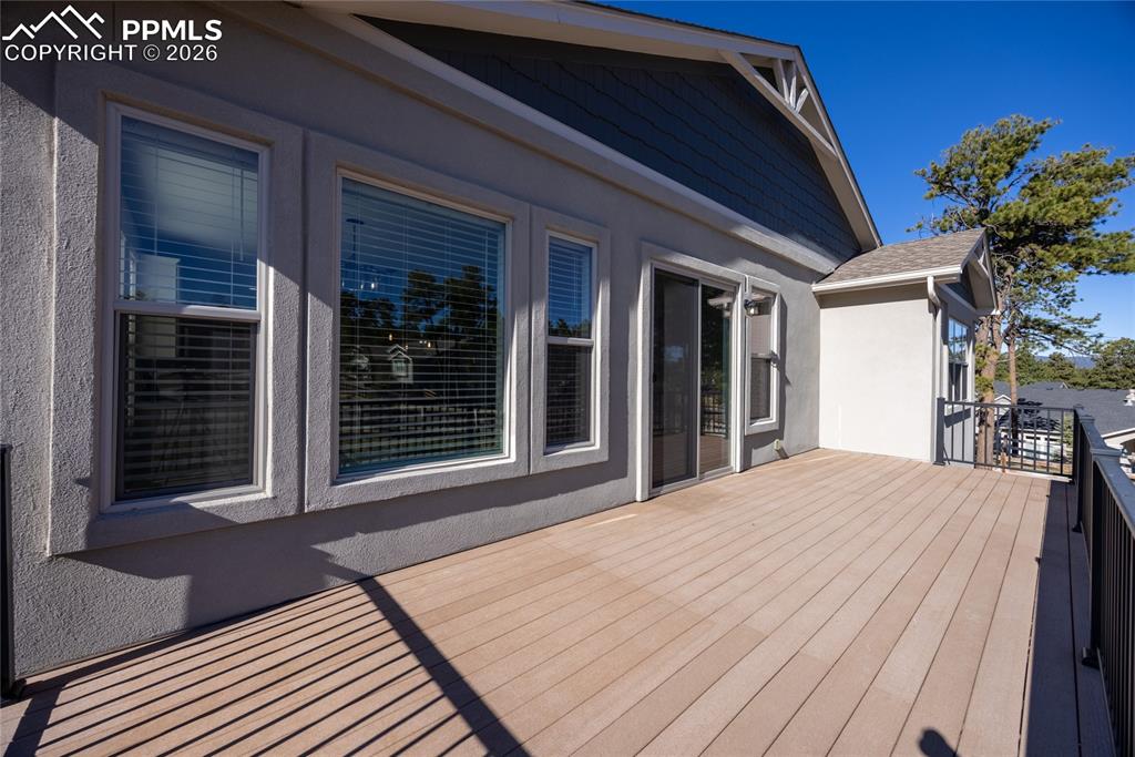 Image 35 of 50: The property features an outdoor deck with light-colored decking and black 
