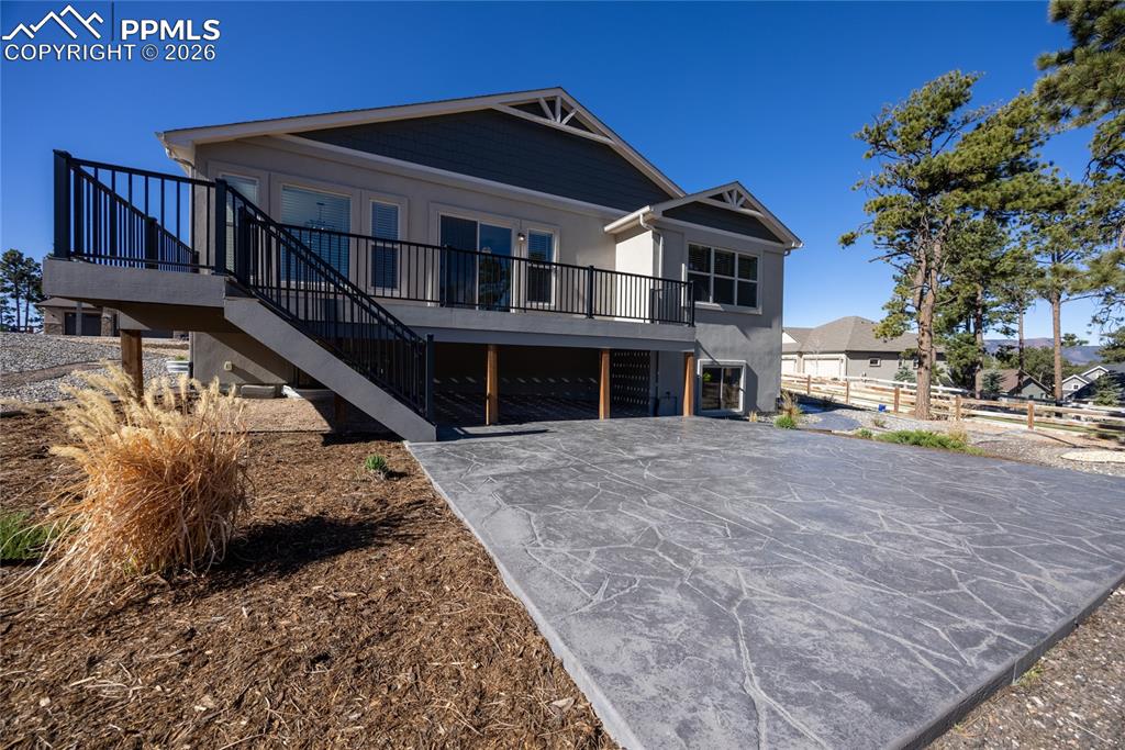 Image 36 of 50: The property features a spacious stamped concrete patio and an elevated dec