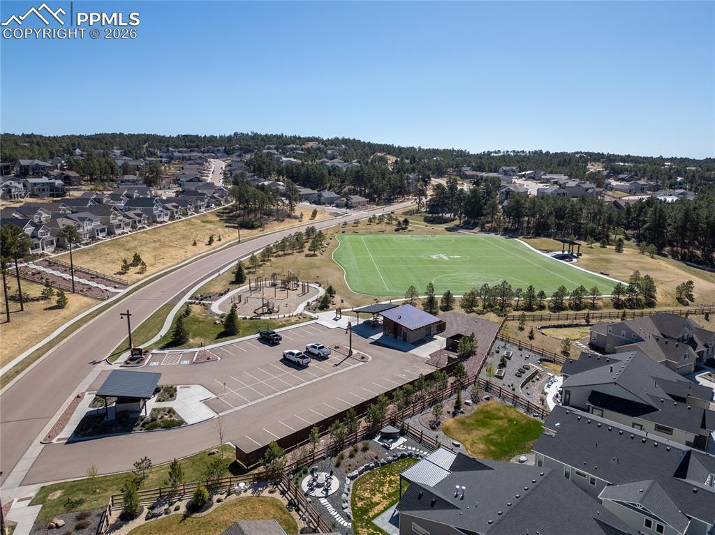 Image 39 of 50: Aerial view showcasing the community amenities including a sports field, pl