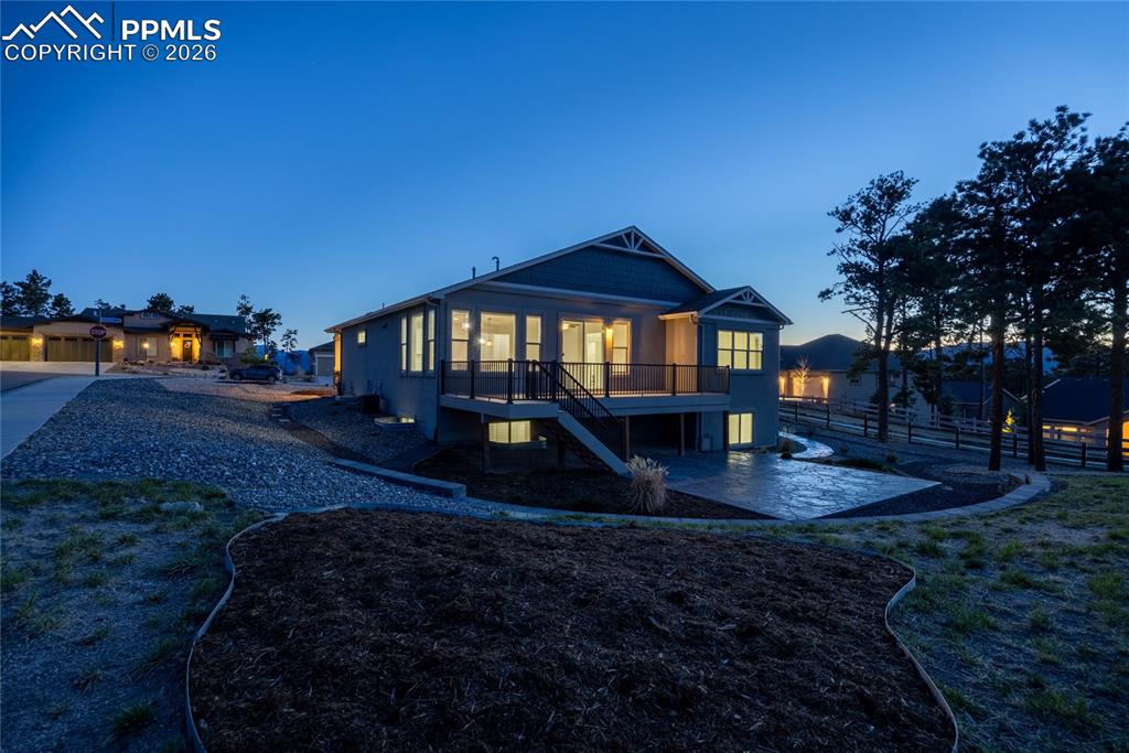 Image 42 of 50: The property features a spacious deck with dark railings, a lower-level pat