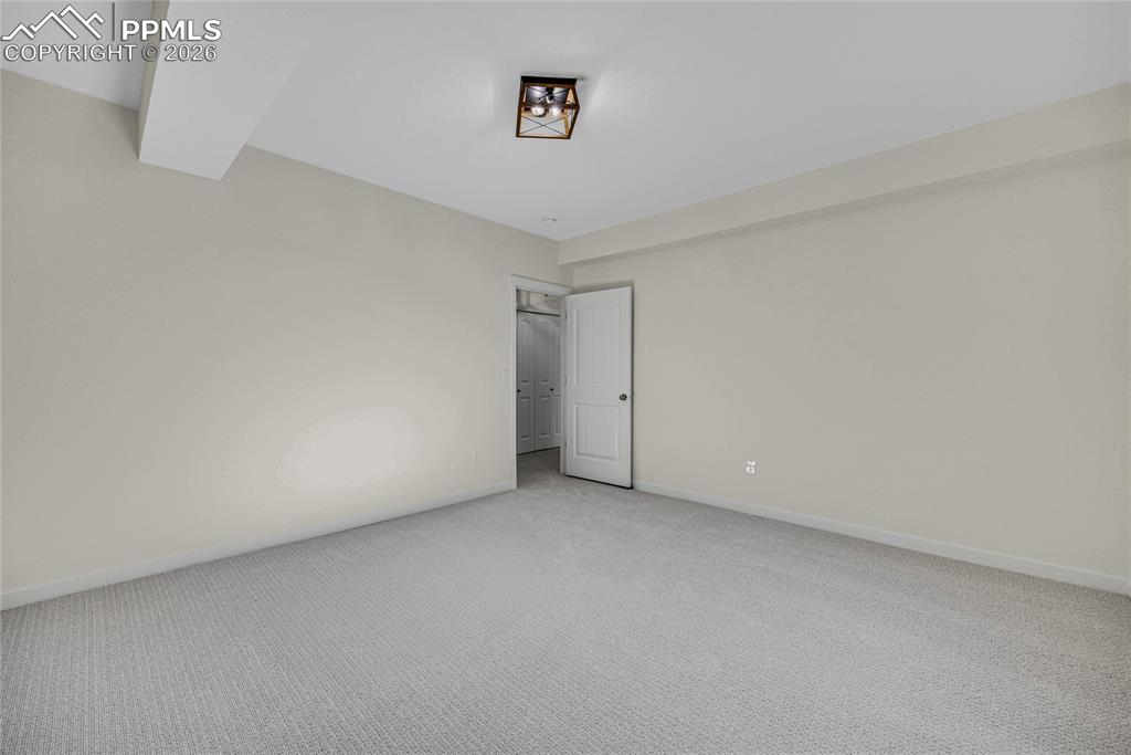 Image 43 of 50: Well-proportioned room featuring light-colored walls and grey carpet floori