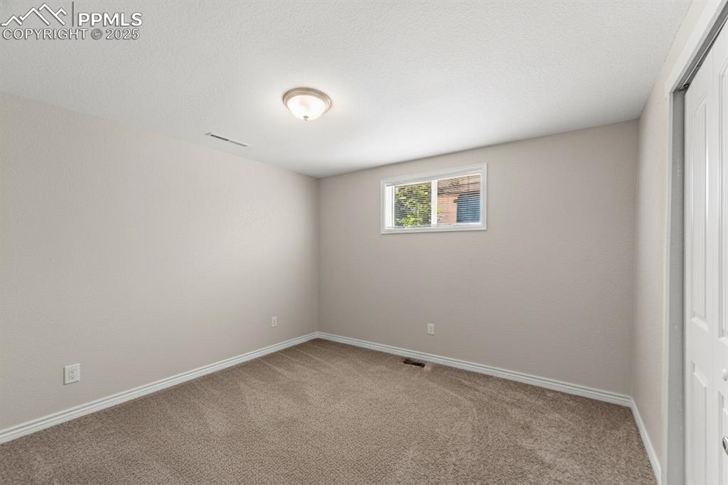 Image 28 of 48: Unfurnished room with light carpet and baseboards