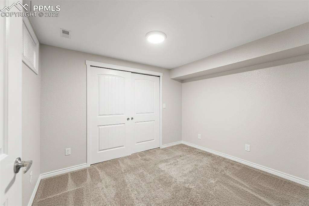 Image 31 of 48: Unfurnished bedroom with carpet flooring and a closet