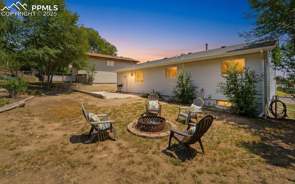 Image 5 of 48: Back of property with a patio area and a fire pit