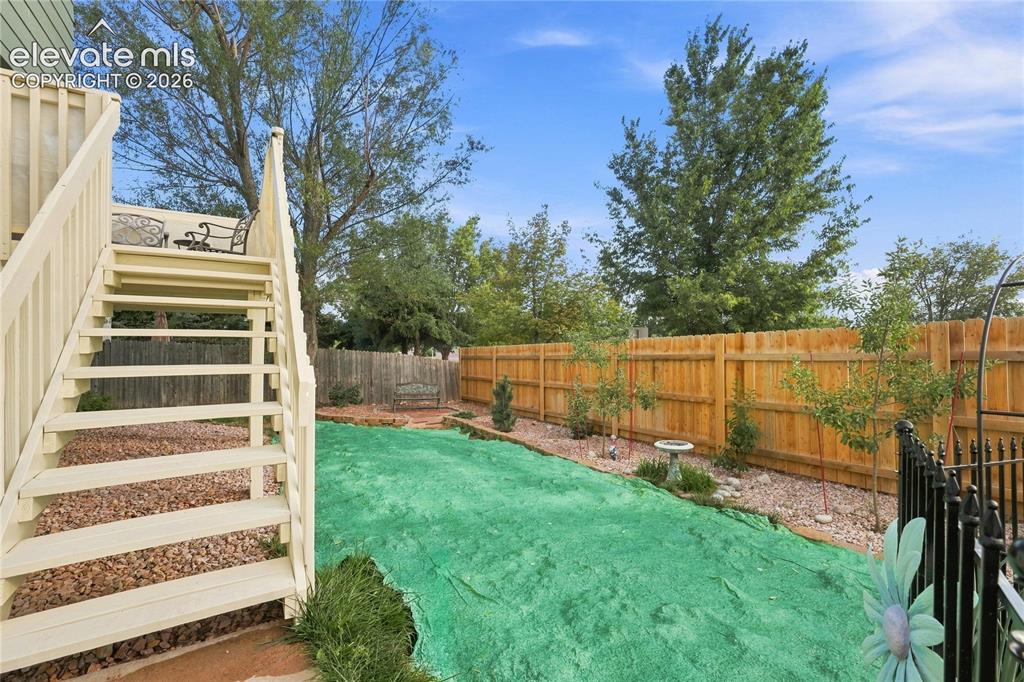 Image 26 of 27: Backyard with raised deck