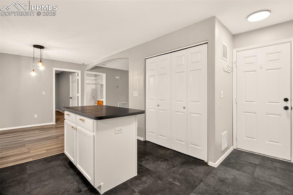 Image 10 of 24: Kitchen offers direct access to the attached garage.