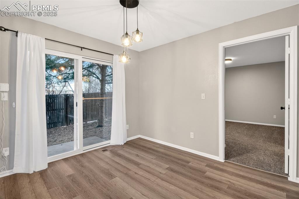 Image 12 of 24: Dining area with walk out access to the backyard.