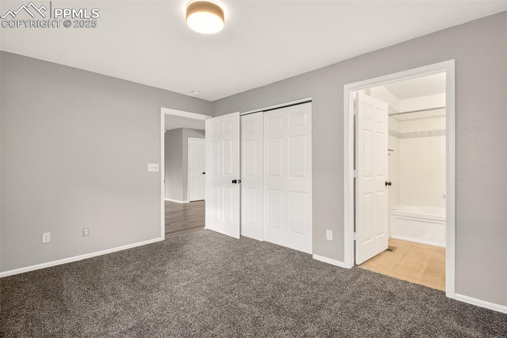 Image 14 of 24: Primary bedroom featuring an en-suite bathroom.