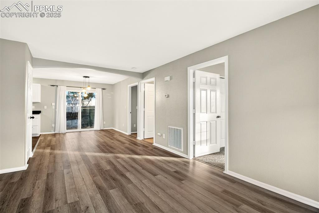 Image 3 of 24: Light and bright living area with newer luxury vinyl plank flooring.