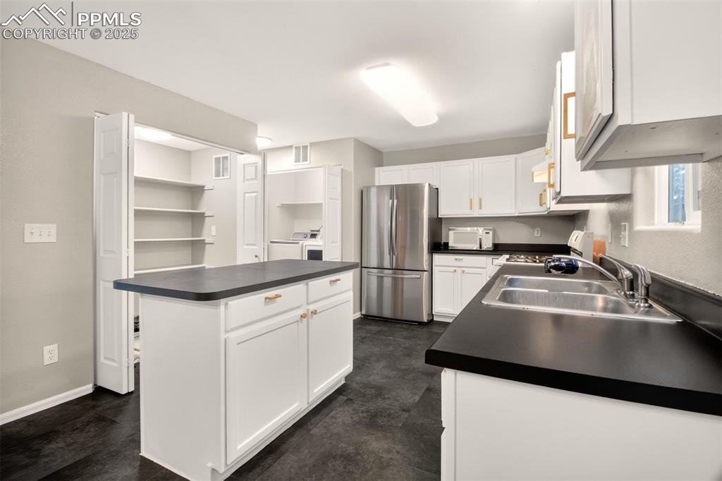 Image 8 of 24: View of large pantry and laundry area.