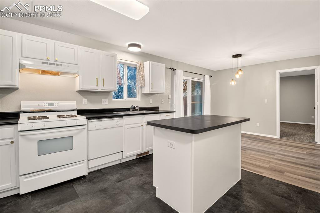 Image 9 of 24: New lighting in kitchen and dining area.