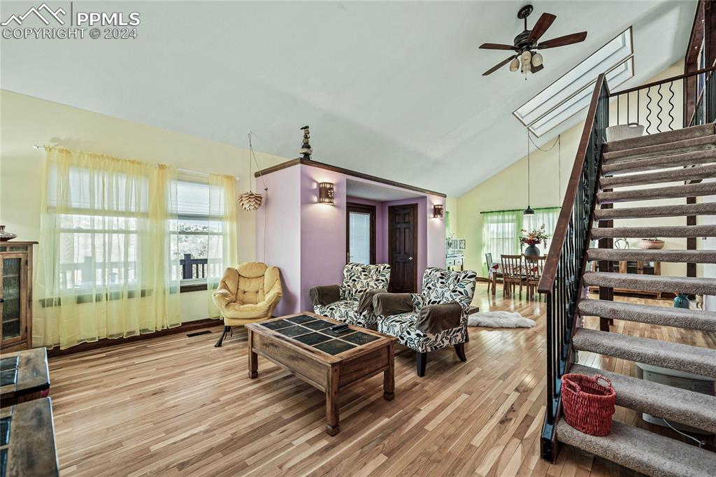 Image 11 of 48: Great Room-Living room featuring hardwood / wood-style flooring, high vault