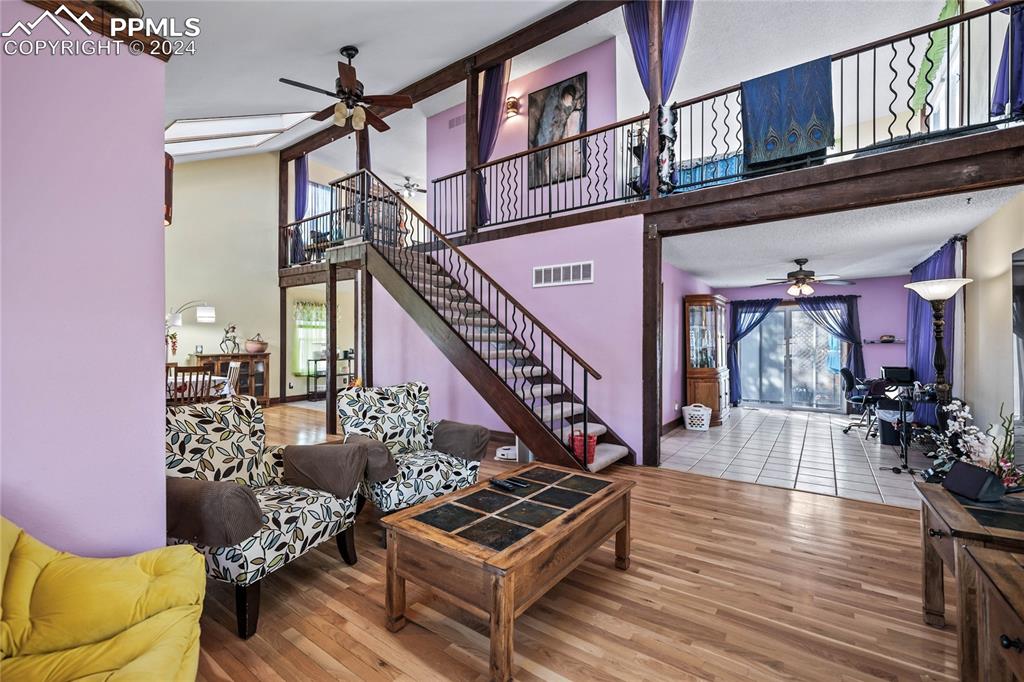 Image 14 of 48: Living room featuring hardwood / wood-style flooring and ceiling fan