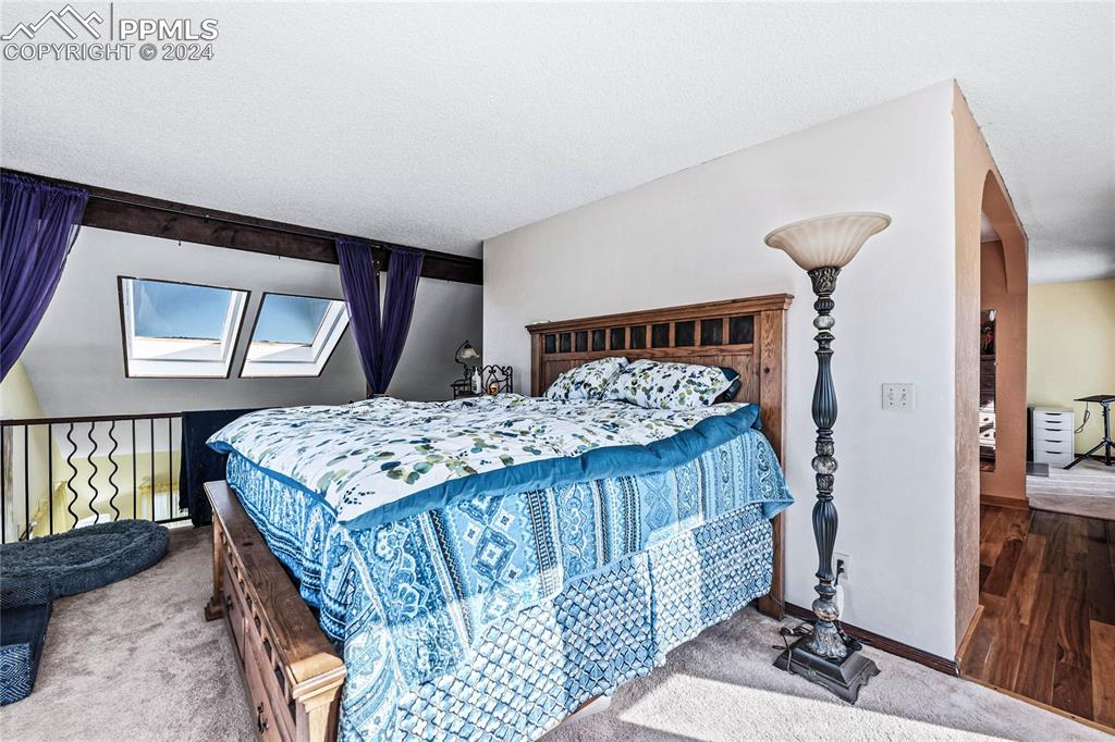Image 15 of 48: Bedroom featuring carpet and a textured ceiling
