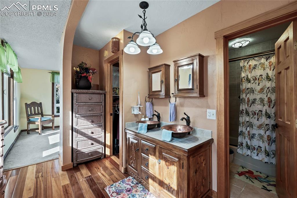 Image 20 of 48: Bathroom with hardwood / wood-style floors, vanity, a textured ceiling, and