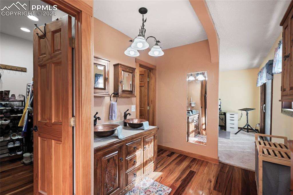 Image 21 of 48: Corridor with dark hardwood / wood-style flooring and sink