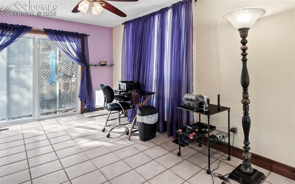 Image 35 of 48: Bonus room adjacent to Kitchen and Great Room-featuring ceiling fan, light 