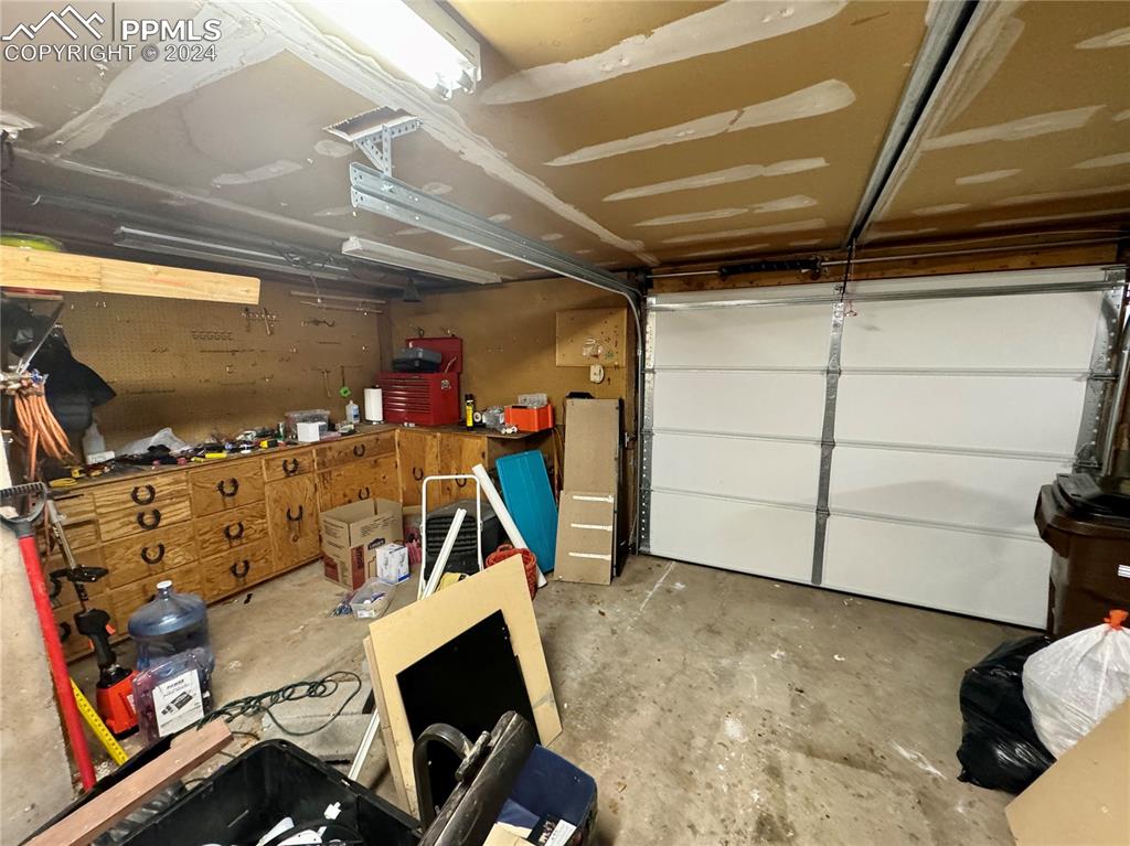 Image 47 of 48: Garage featuring a workshop area