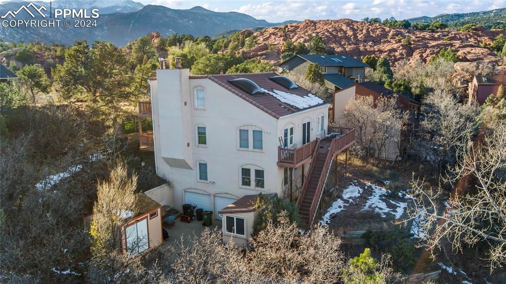 Image 8 of 48: Birds eye view of property with a mountain view