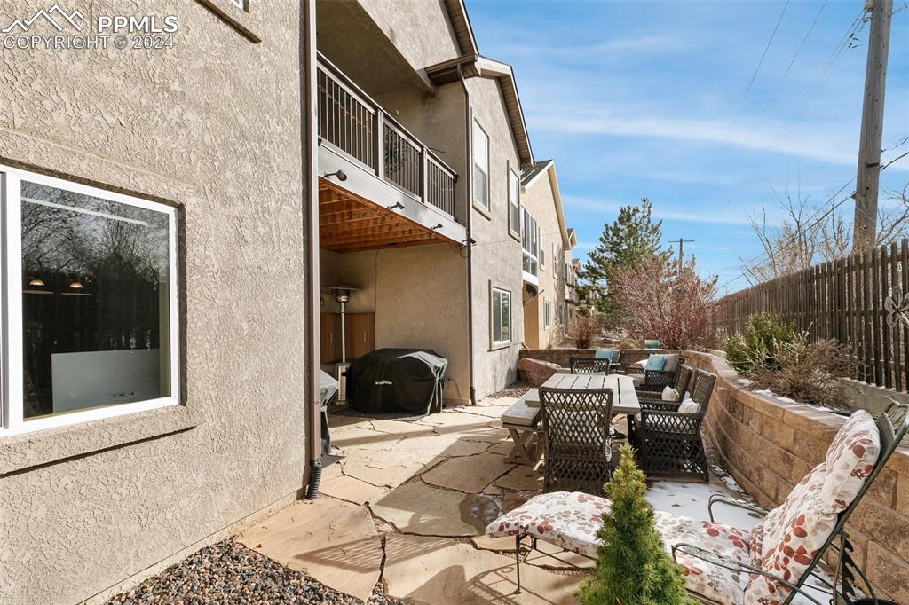 Image 38 of 39: Flag stone patio is accessed from the walk-out basement; there are gas line