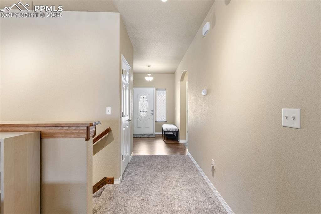 Image 4 of 39: Looking from living room to front door.
