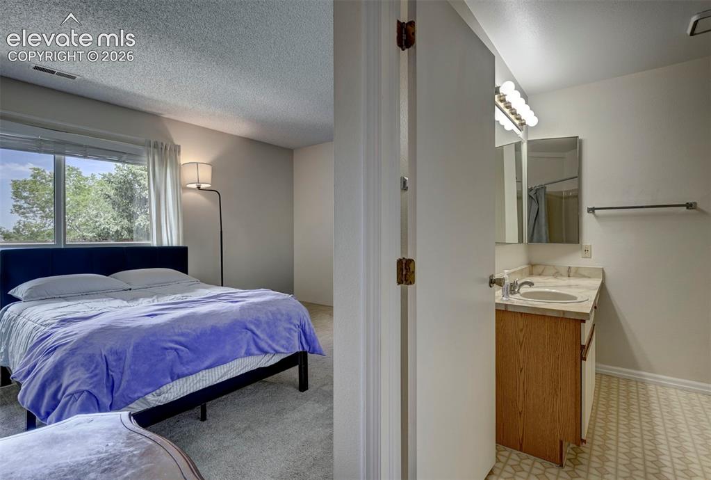 Image 14 of 25: 2nd Primary Bedroom featuring large closet space and ensuite bath