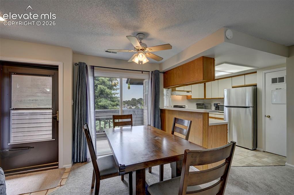 Image 4 of 25: Dining area features a Breakfast Bar and Walk-Out- Deck Area