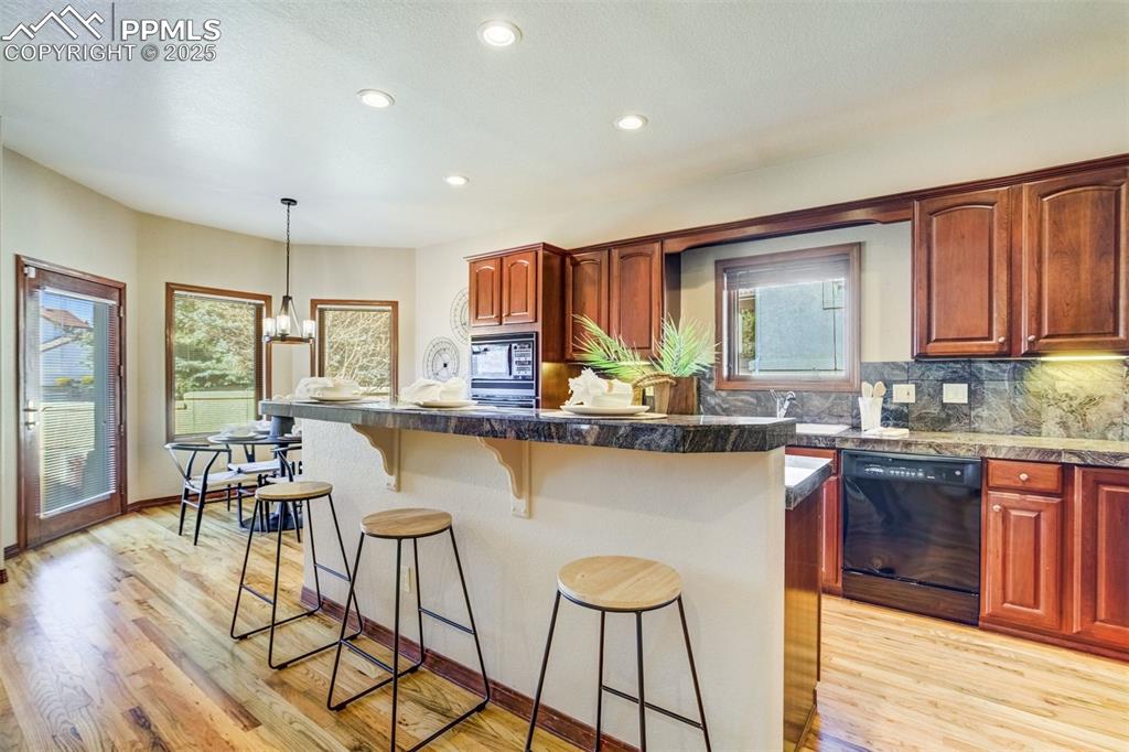 Image 10 of 49: Open kitchen with Oakwood floors.