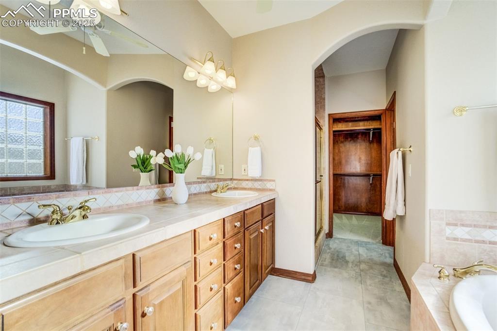 Image 22 of 49: Dual vanity in the 5-piece bathroom.