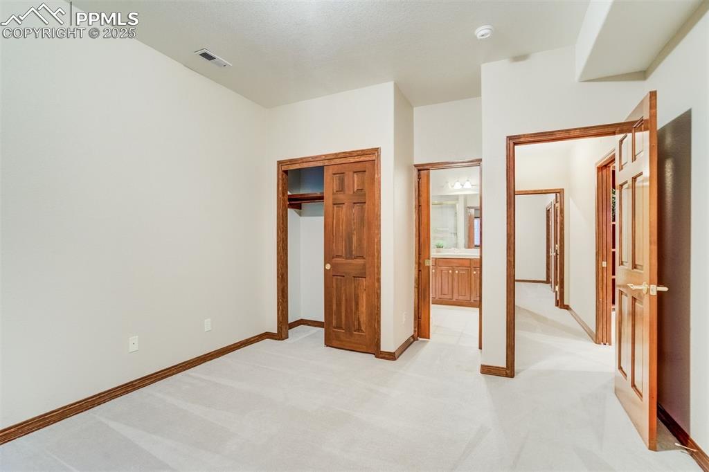 Image 38 of 49: Bedroom 2 in the basement with access to the Jack-N-Jill bathroom.