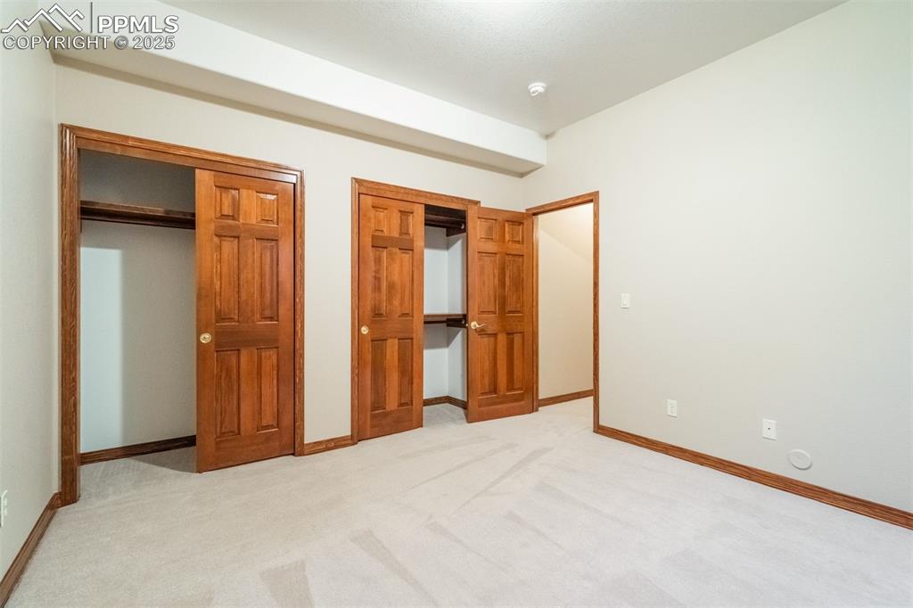Image 41 of 49: Bedroom 3 in the basement has dual closets. All bedrooms are very generous