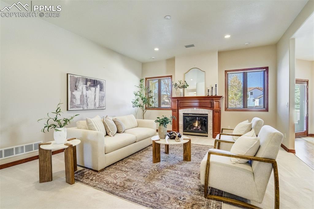 Image 9 of 49: Gas fireplace with custom wood mantel surround.