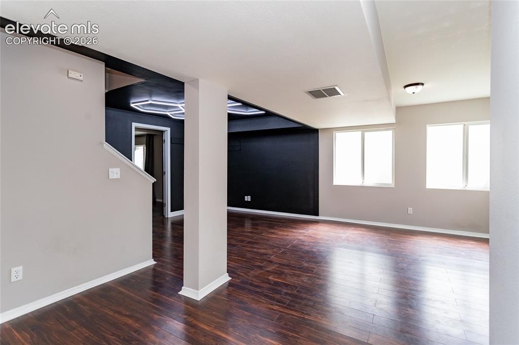 Image 40 of 50: Large finished basement with space for seating, TV, fitness equipment, use 