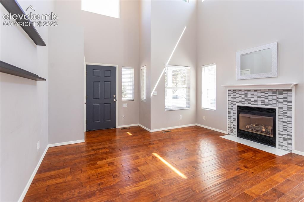 Image 6 of 50: Living room featuring gas fireplas